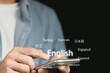 © Ei - Translator app, language course and e-learning concept. Person use smartphone with Translator app, translation or translate on the mobile app worldwide language conversation speaking concept.