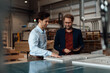 © BusinessClass by W61 - Mature businessman with colleague touching wood in industry