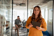 © BusinessClass by W61 - Smiling businesswoman holding tablet PC and standing in office