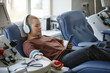© BusinessClass by W61 - Woman donating blood and listening to music