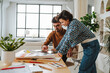 © BusinessClass by W61 - Colleague leaning on desk with illustrator using graphic tablet at office
