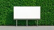 © MD. ABDUS SALAM - Blank billboard displayed against a lush green vertical garden wall