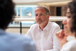 © BusinessClass by W61 - Senior businessman listening discussion of colleagues in meeting