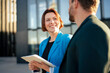 © BusinessClass by W61 - Smiling businesswoman with tablet PC looking at colleague on sunny day