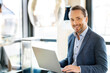 © BusinessClass by W61 - Happy businessman with laptop in office cafeteria