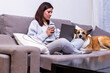 © Ivi - Powerlightss - Woman working from home with her dog and drinking coffee