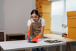 © crizzystudio - Young asian woman cleaning desk in warehouse office