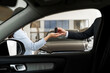 © Maria Vitkovska - Salesman giving car keys to customer in dealership showroom