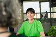 © BusinessClass by W61 - Smiling woman with colleague wearing green t-shirt in office