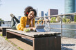 © BusinessClass by W61 - Businesswoman listening music and working on laptop by River Main