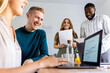 © BusinessClass by W61 - Smiling multiracial business colleagues in office meeting
