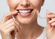 © DFN99 - Woman Holding Clear Orthodontic Aligners and Smiling, Dental Alignment Treatment in Progress, Confident Patient Ready to Correct Imperfections