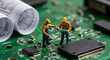 © Lionel - Miniature Workers Reading a blueprint next to a circuit diagram on Circuit Board