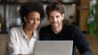 © Nataliya - Multiethnic couple managing finances on a laptop at home