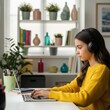 © Joy - Young girl wearing headphones and studying online using a laptop at home
