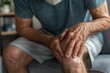 © Ольга Лукьяненко - Elderly man holds stiff leg in pain from arthritis