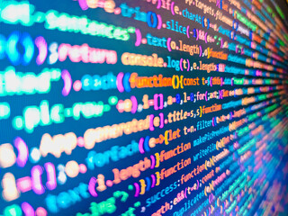 computer code background. colorful programming source typed on the screen of the monitor with shallo