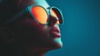 © Juan - Young woman wearing stylish sunglasses on blue background with reflection for fashion accessory branding product scene