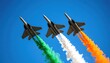 © Igor_Tichonow - Three fighter jets fly in formation leaving tricolor smoke trails representing the Indian flag during an air show on a clear blue sky day