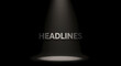 © mommy - Spotlight Illuminating 'HEADLINES' Text on Dark Background Representing Breaking News and Important Announcements