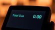 © Ms Vector - A closeup of a payment terminal screen displaying a total due of zero dollars and zero cents