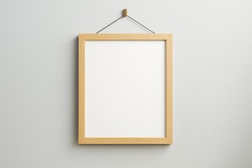 Wall Mural - minimalistic wooden photo frame hanging on light wall with blank white space for artwork, poster or 