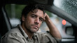 © Ali Hamza Tullah - Portrait of emotionally distressed man sitting in damaged car after minor accident, showing exhaustion and stress with cracked windshield, dim lights, and rainy urban street outside, car accident afte