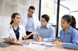© SOMKID - Medical team having a meeting in conference room at hospital, Medical technology and health care concept.