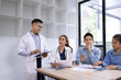 © SOMKID - Medical team having a meeting in conference room at hospital, Medical technology and health care concept.