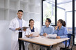 © SOMKID - Medical team having a meeting in conference room at hospital, Medical technology and health care concept.