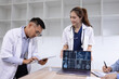 © SOMKID - Medical team with laptop computer and examine x ray test results for treatment plans in a modern hospital, Healthcare and medical concept.