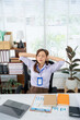 © Kritdanai - Office Stress: A businesswoman appears overwhelmed by workplace stress, closing her eyes in an attempt to find serenity in the office, surrounded by the trappings of her career.