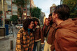 © bernardbodo - Happy multiracial friends laughing together on city street