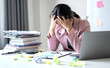 © Orathai - Working Asian women feel stressed, tired from work, migraine headaches from hard work while working at the office
