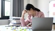 © Orathai - Working Asian women feel stressed, tired from work, migraine headaches from hard work while working at the office