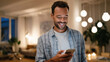 © Niks Ads - young handsome man using smartphone standing at home