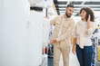 © Serhii - Couple choosing water heater in electronics store