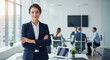 © DeadCat - Confident businesswoman in office suit with arms crossed, standing in corporate environment