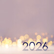 © Anna - Metal numbers 2026 on a white table with Christmas trees and bokeh lights. Happy New Year 2026 is coming concept.