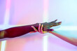 © ADDICTIVE STOCK - Multiethnic hands in vibrant colored light