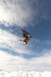 © ADDICTIVE STOCK - Freestyle snowboarder soaring through the winter sky