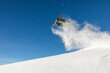 © ADDICTIVE STOCK - Snowboarder soaring through fresh powder in mountains