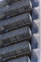 Modern metal staircases line urban high-rise