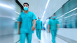 © Curioso.Photography - Medical staff in scrubs walking through a clean and modern hospital hallway.