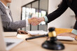 © SOMKID - Lawyer Handshake in Business Meeting, Agreement and Partnership, Hammer of Justice,