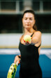 © Darius - Young woman showcases her skills in padel while preparing to serve a ball on the court