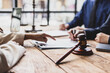 © Wasan - Lawyers and clients signing contract agreement after legal advice consultation. Lawyers and clients are signing contract agreements on a wooden table, legal proceedings and agreement.