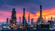 © Nail - Oil refinery at dusk with glowing lights, complex piping, and tall towers against a colorful sky. Concept:Energy production, industrial infrastructure, oil and gas industry, petrochemical processing,
