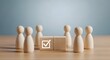 © lisha - Understanding voting process and election integrity concept with wooden figures and check mark