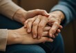 © designneed - Two people hold hands in a display of comfort and support